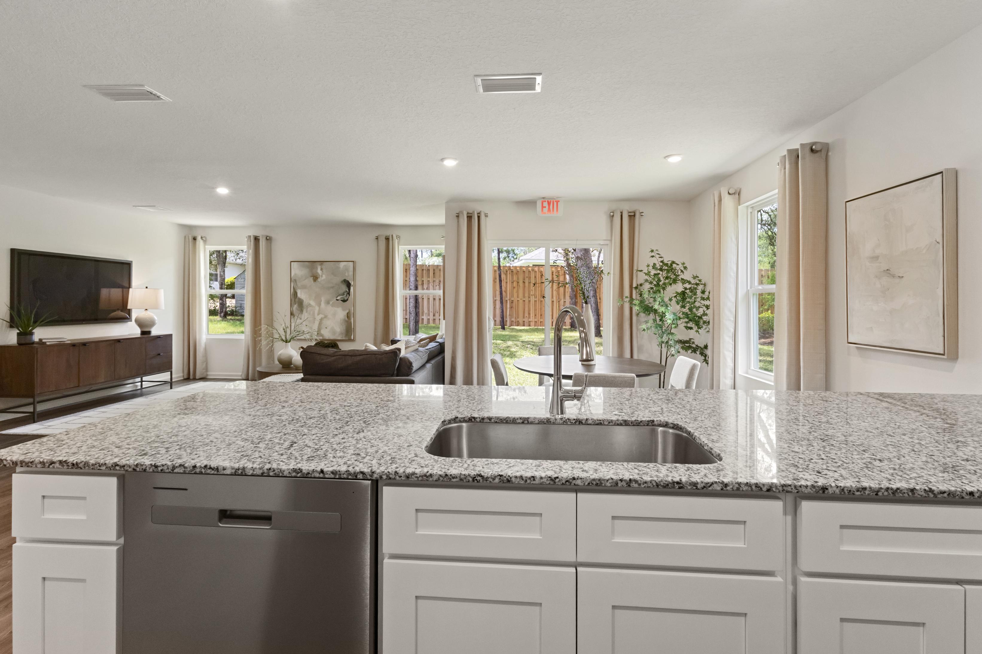 A large kitchen with marble counters.