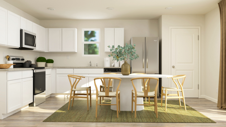 A kitchen with white cabinets.